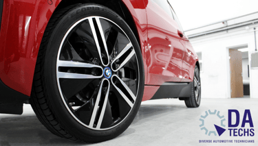 Red BMW diamond cut alloy wheel with DA Techs - Diverse Automotive Technicians logo