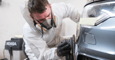 Body Repair Technician repairing damage to Audi car