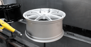 Alloy wheel powder coated before being baked in the oven